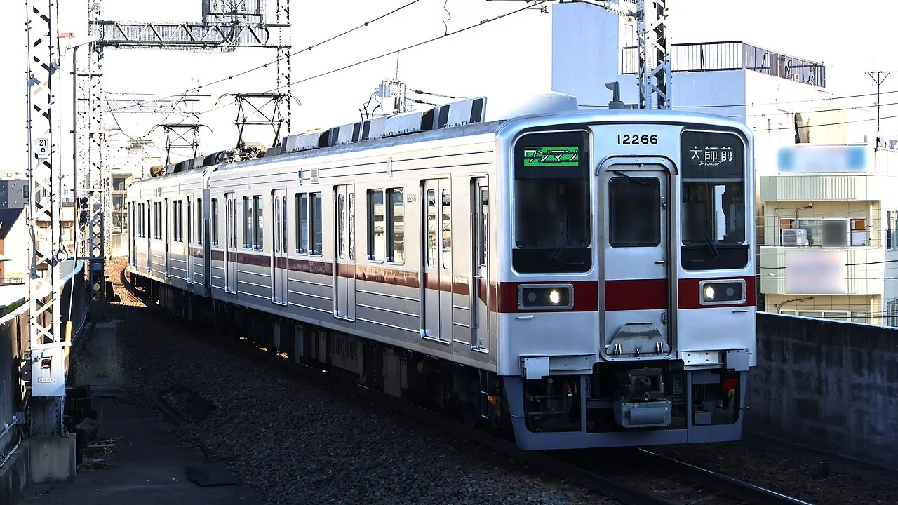 A two-car Tobu Daishi Line train approaching Daishimae Station in Tokyo