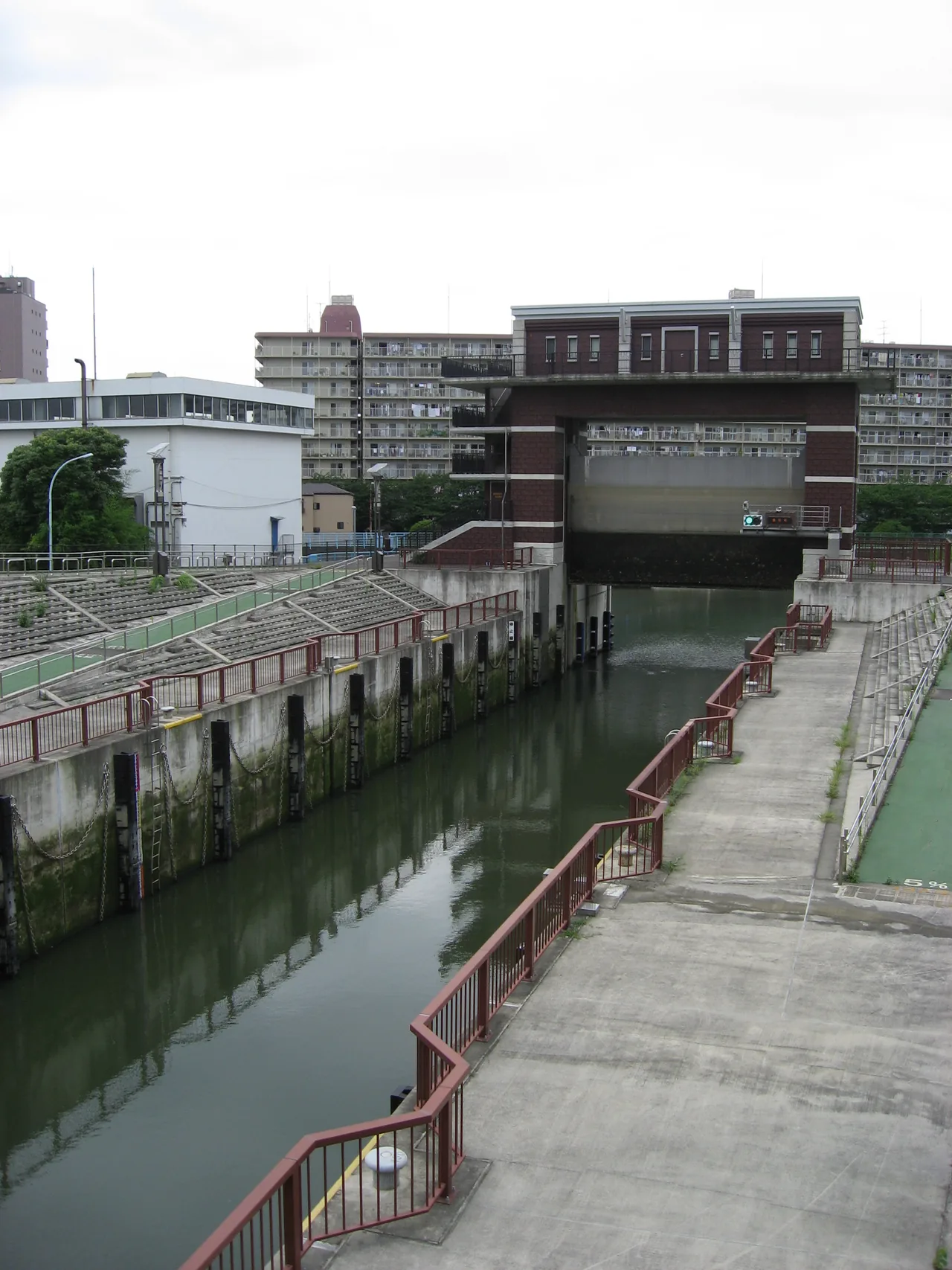 The tall concrete towers and water chamber of the modern Arakawa Lock Gate