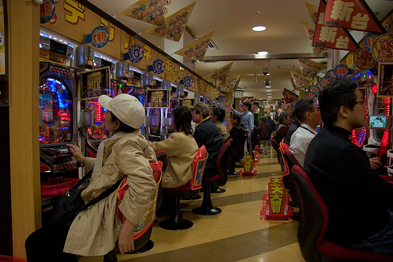 Rows of pachinko machines and players inside a pachinko hall in Japan